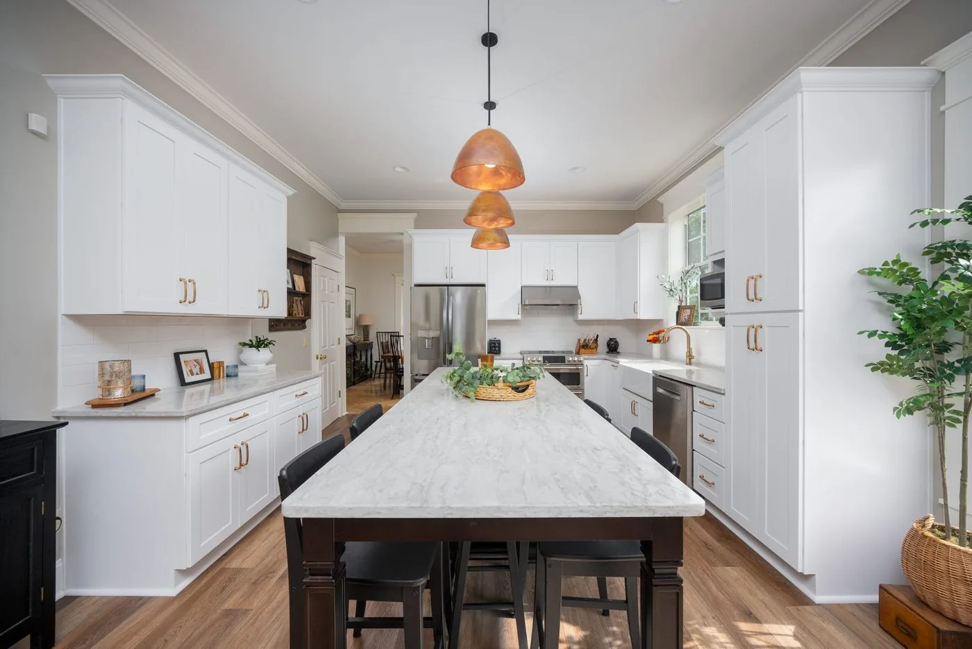 Fort Caroline kitchen with a long marble island and copper pendants