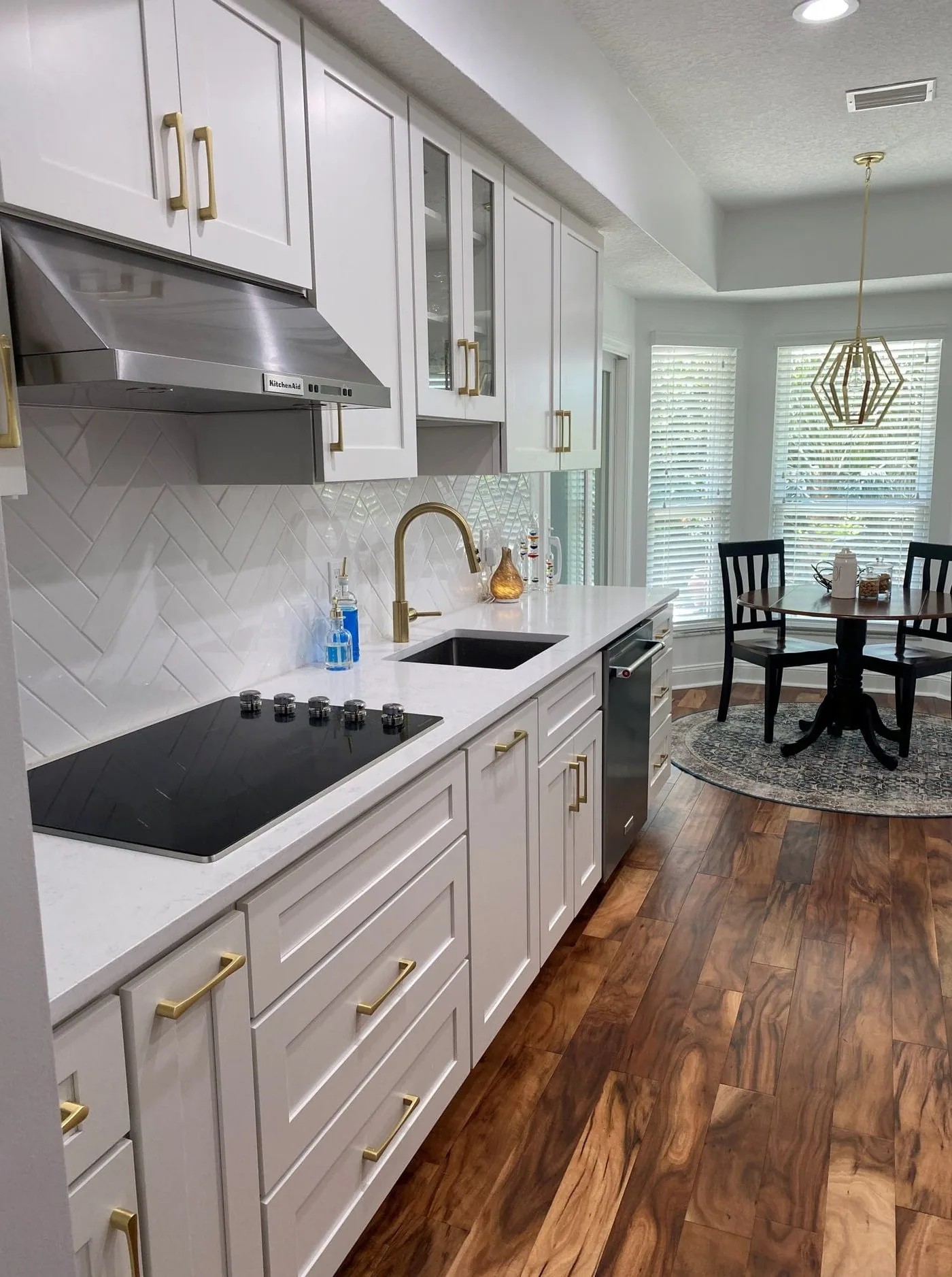 San Marco kitchen with a painted range hood, brass hardware and dark wood floors